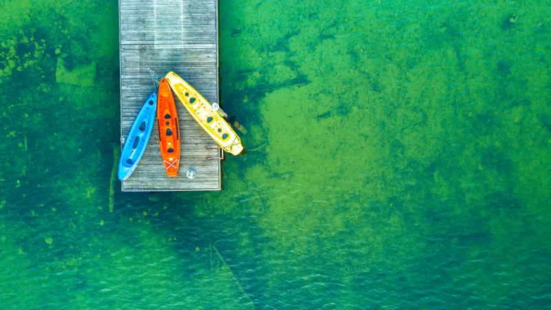 Kayaks on wooden pier, Aerial view, Green lake, 4K wallpaper