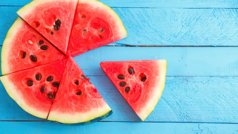 Watermelon pieces, Wooden background