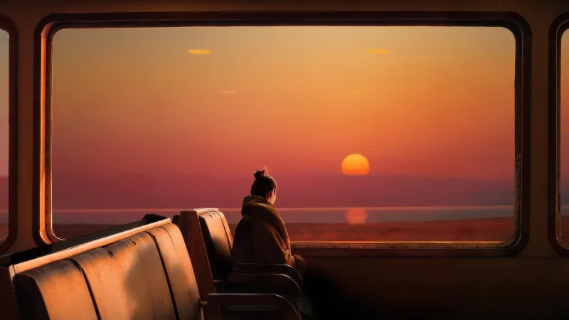 Woman on a train at sunset, Window view, Golden light, 4K wallpaper