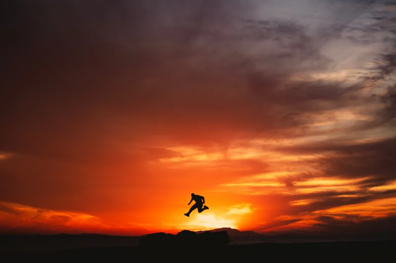 Jumping man silhouette, Fiery sunset, Hisma Desert, 8K wallpaper